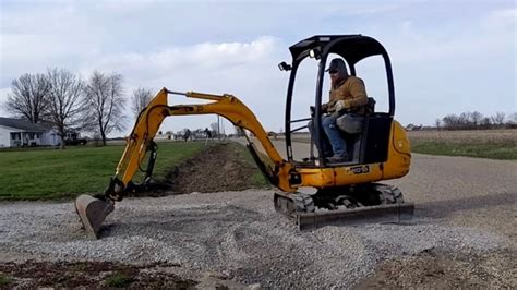 mini excavator digging driveway|mini excavator training for beginner.